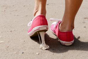 Foot stuck into chewing gum on street