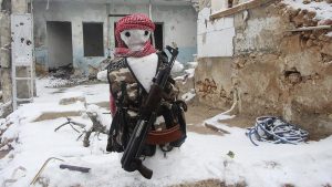 A snowman made to look like a Free Syrian Army fighter is pictured in Aleppo's Karm al-Jabal district, December 13,2013. Picture taken December 13, 2013. REUTERS/Saad AboBrahim (SYRIA - Tags: POLITICS CIVIL UNREST CONFLICT) - RTX16JZT