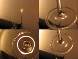 Il fondo di un calice da vino deforma la luce della candela come una lente gravitazionale deforma la luce di una galassia lontana